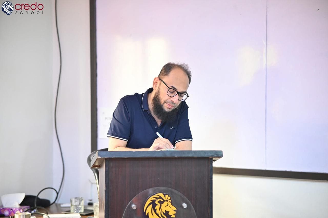 Shahab Yakoob working at a classroom podium